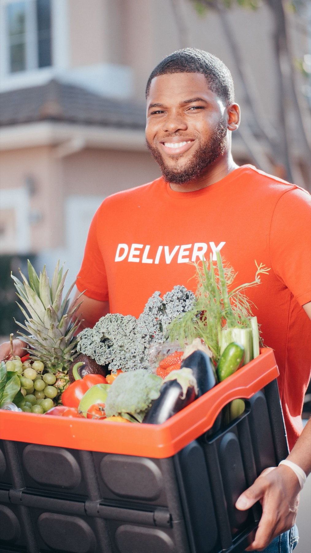 Grocery delivery professional carrying fresh produce